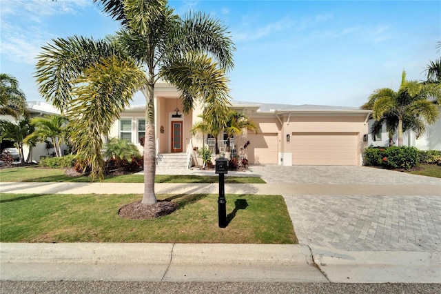 view of front of home featuring a front yard and a garage