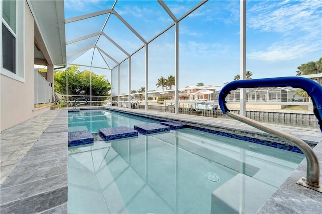 view of swimming pool with a patio area, glass enclosure, and an in ground hot tub