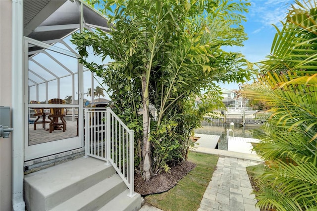 view of patio featuring glass enclosure