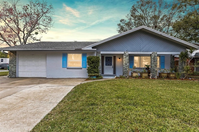 ranch-style house featuring a yard and a garage