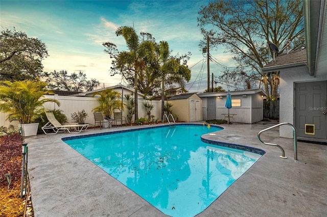 view of pool featuring a patio and a storage unit