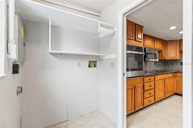 kitchen with decorative backsplash and appliances with stainless steel finishes