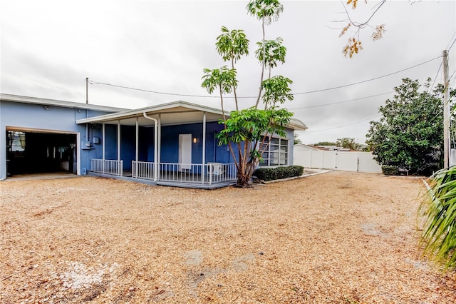 back of property featuring a garage and a porch