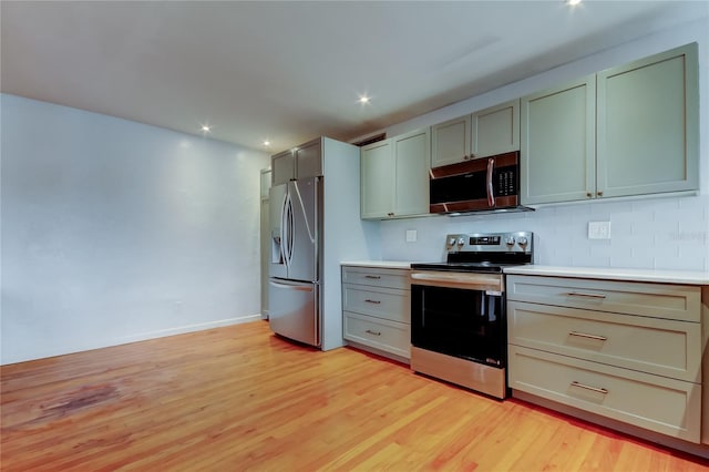 kitchen featuring stainless steel appliances and light hardwood / wood-style flooring