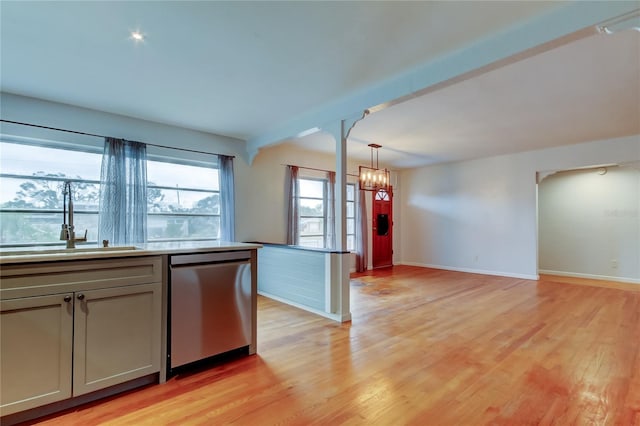 kitchen with pendant lighting, dishwasher, sink, a notable chandelier, and light wood-type flooring