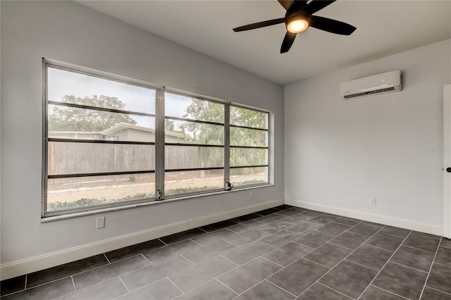 unfurnished room featuring ceiling fan, dark tile patterned flooring, and an AC wall unit