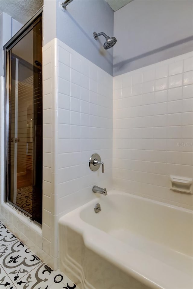 bathroom with tub / shower combination and tile patterned flooring