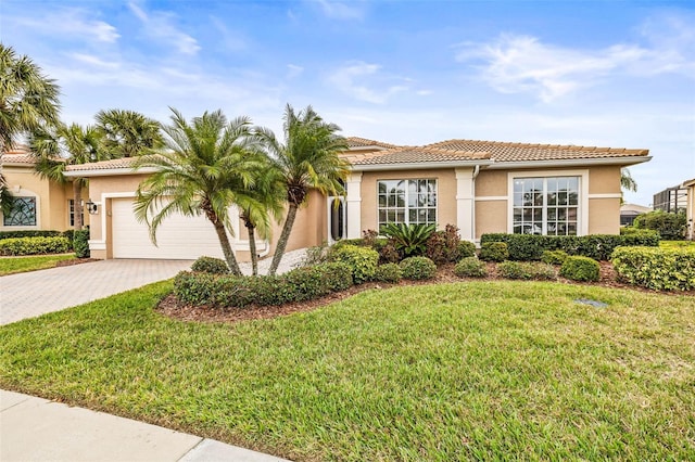 mediterranean / spanish-style house with a front lawn and a garage