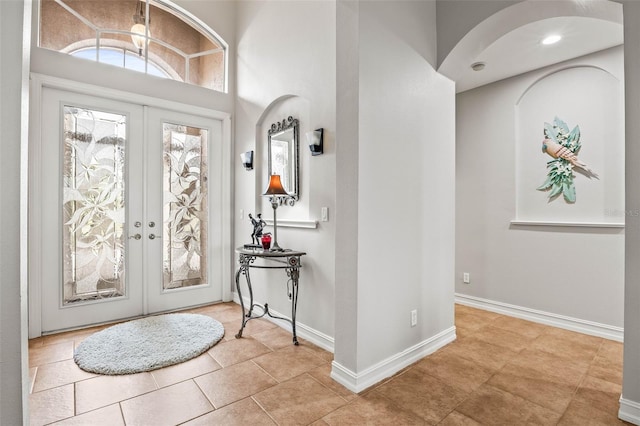 entrance foyer featuring french doors and light tile patterned flooring