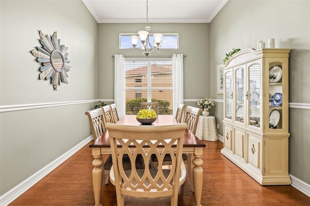 dining area with an inviting chandelier, dark hardwood / wood-style flooring, and ornamental molding