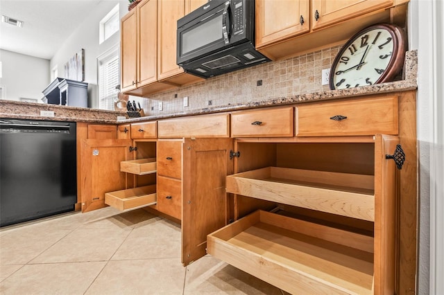 kitchen with black appliances, light stone countertops, and tasteful backsplash