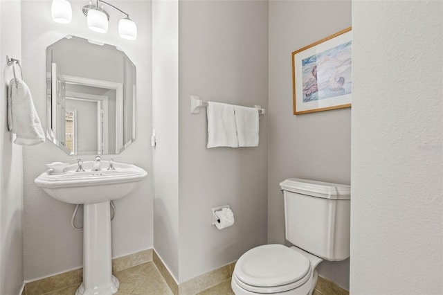 bathroom featuring toilet and tile patterned flooring