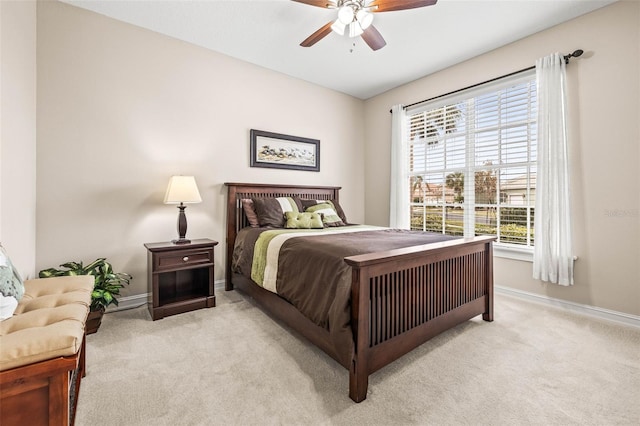 bedroom with ceiling fan, light carpet, and multiple windows