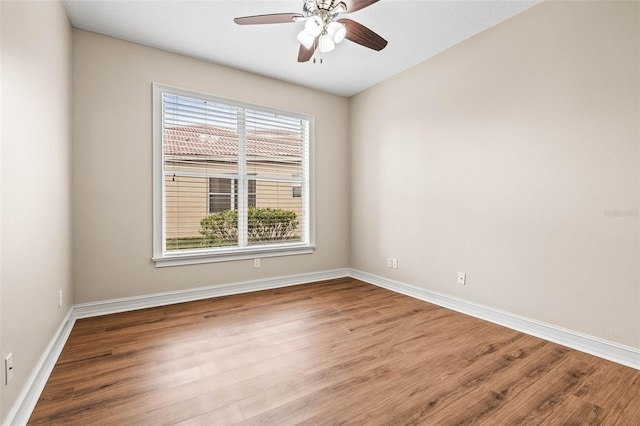 empty room with ceiling fan and light hardwood / wood-style flooring