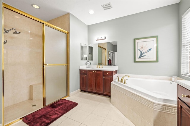 bathroom featuring tile patterned flooring, shower with separate bathtub, and vanity