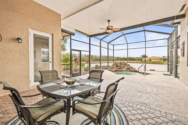 view of patio / terrace with a lanai and a water view