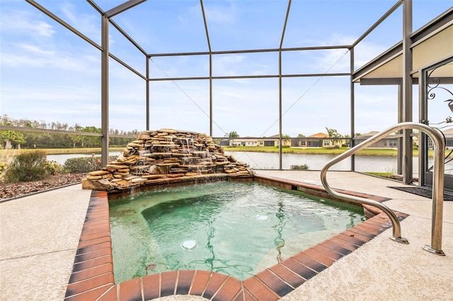 view of pool featuring glass enclosure, a patio area, and a water view