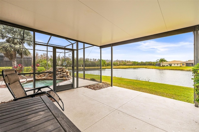 unfurnished sunroom with a water view