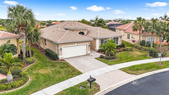 mediterranean / spanish-style house featuring a garage and a front yard