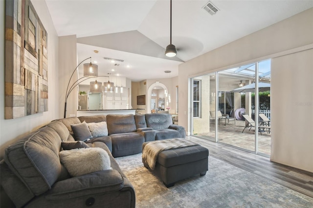 living room with ceiling fan, hardwood / wood-style floors, and lofted ceiling