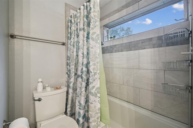 bathroom featuring shower / bath combo with shower curtain and toilet