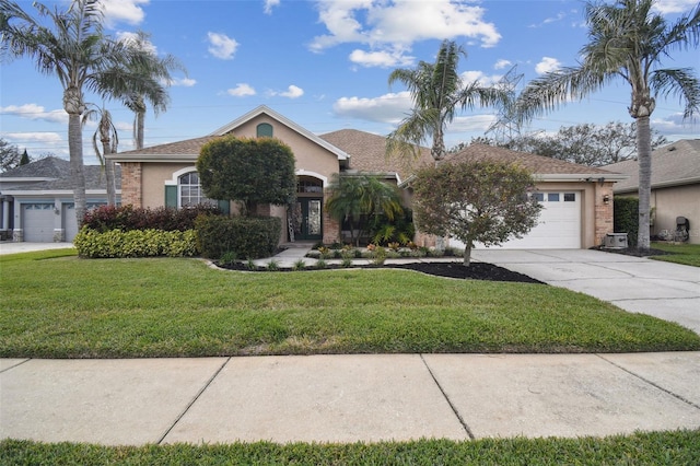 view of front of home featuring a front yard and a garage