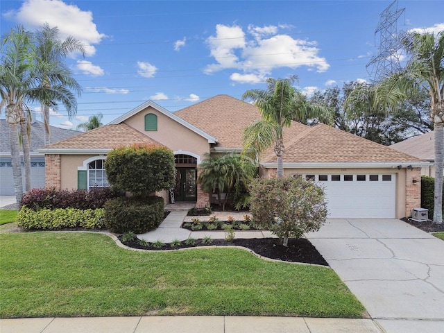 view of front of house with a front lawn, a garage, and french doors