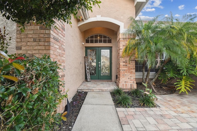 view of exterior entry featuring french doors