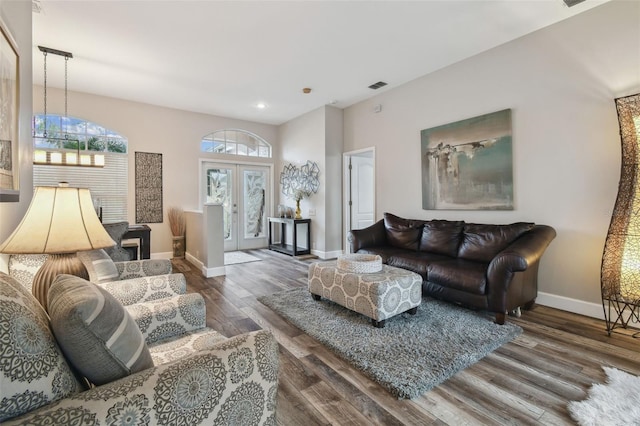 living room with dark hardwood / wood-style floors and french doors