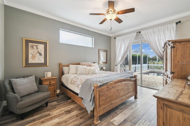 bedroom featuring ceiling fan, access to exterior, hardwood / wood-style flooring, and multiple windows