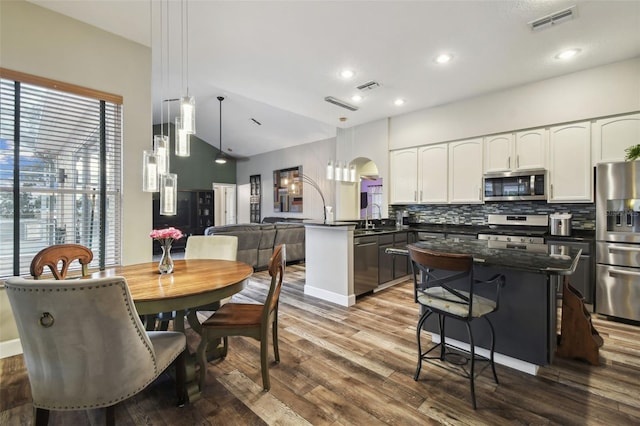 kitchen featuring tasteful backsplash, pendant lighting, sink, appliances with stainless steel finishes, and white cabinets