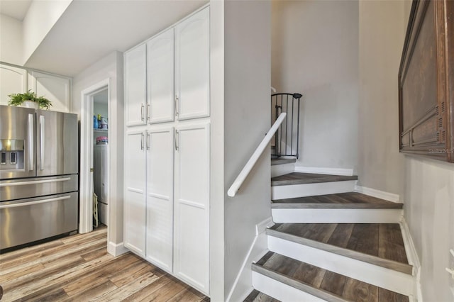 staircase with hardwood / wood-style flooring