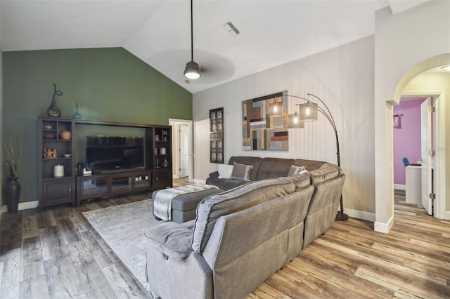 living room with ceiling fan, hardwood / wood-style flooring, and lofted ceiling