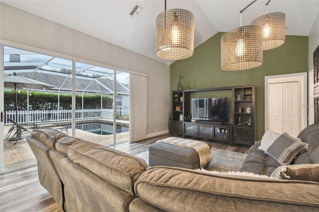 living room featuring wood-type flooring and vaulted ceiling