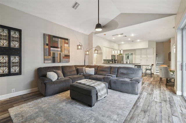 living room with vaulted ceiling, ceiling fan, and light hardwood / wood-style flooring