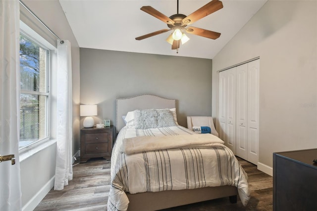 bedroom featuring ceiling fan, a closet, vaulted ceiling, and hardwood / wood-style flooring