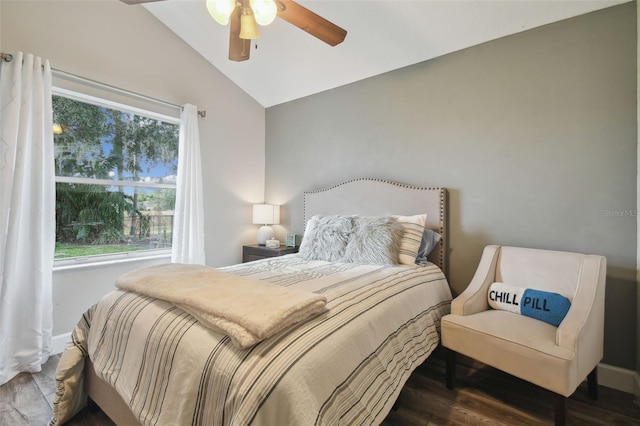 bedroom featuring ceiling fan, multiple windows, hardwood / wood-style flooring, and vaulted ceiling