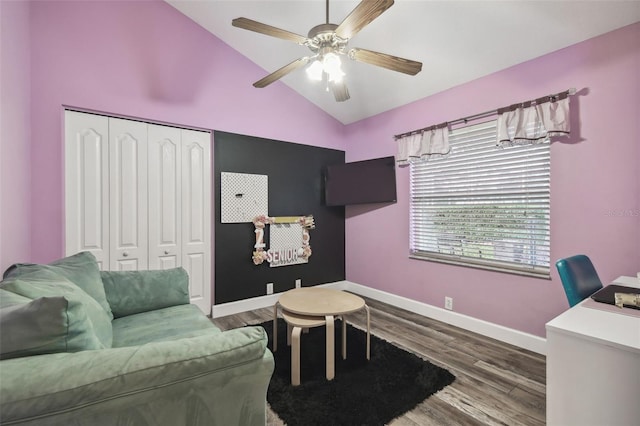 interior space with ceiling fan, lofted ceiling, and wood-type flooring