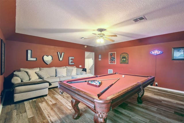 rec room with a textured ceiling, ceiling fan, wood-type flooring, and billiards