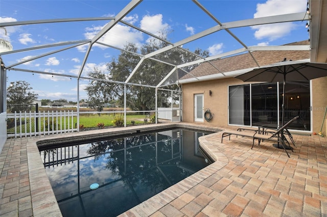 view of swimming pool with a lanai and a patio