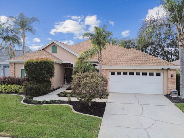 view of front of home featuring a front yard and a garage