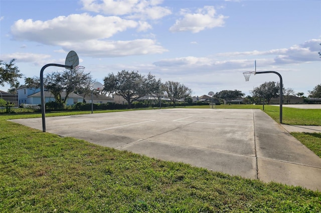 view of sport court featuring a lawn