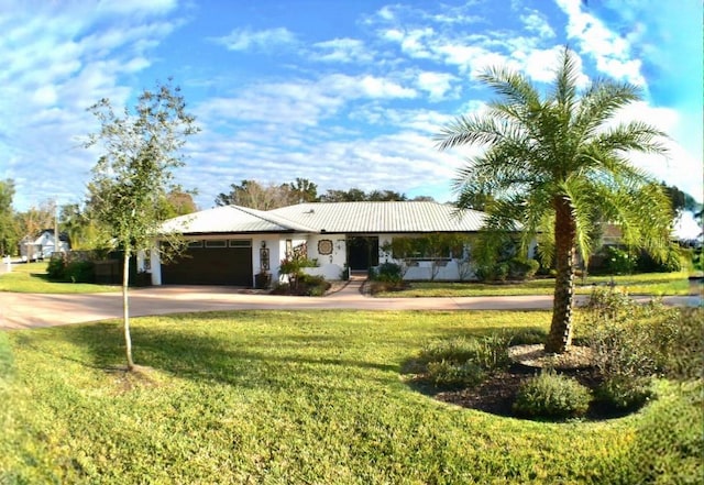 ranch-style home with a garage and a front yard