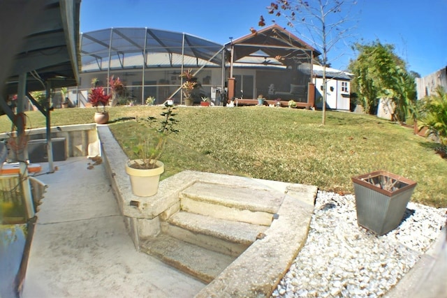 view of yard featuring a patio area and glass enclosure