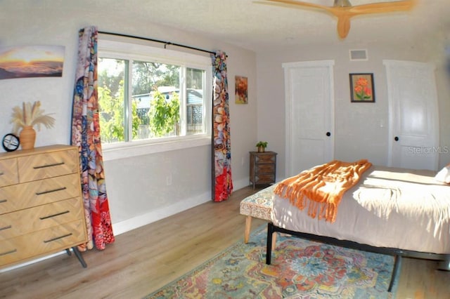 bedroom with ceiling fan and wood-type flooring