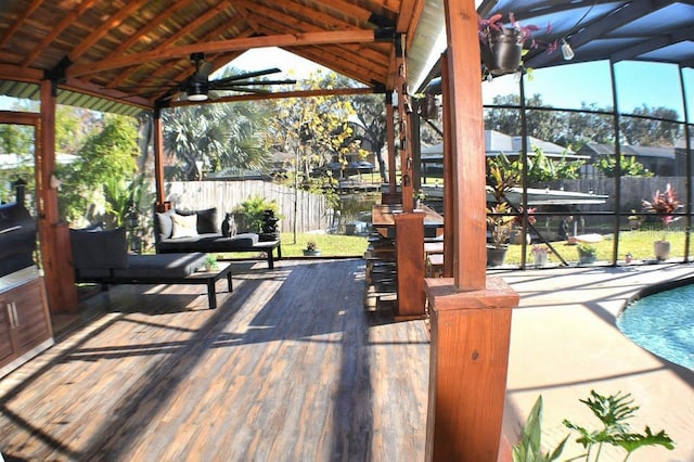 view of patio / terrace with ceiling fan and a fenced in pool