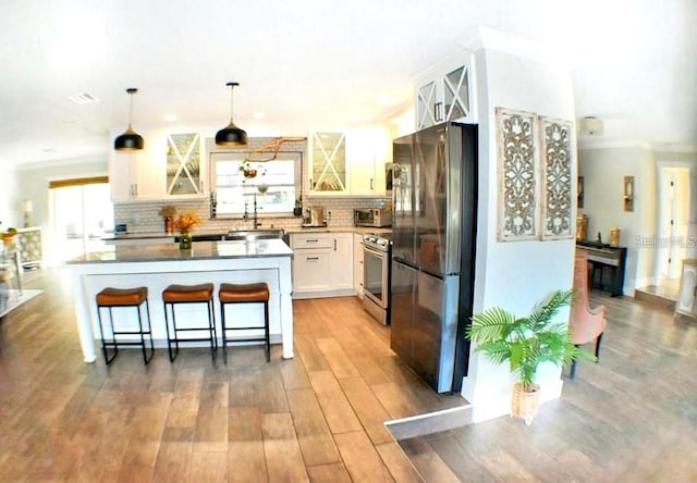 225 Temple Cir, Eustis, FL 32726 - kitchen with stainless steel appliances, glass insert cabinets, decorative backsplash, white cabinets, and crown molding