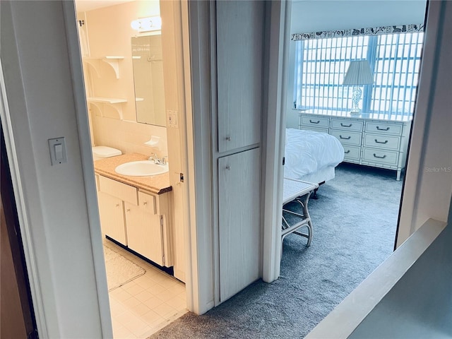 hallway with sink and carpet floors