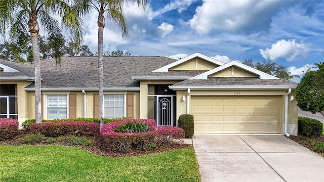 view of front of home featuring a front lawn and a garage