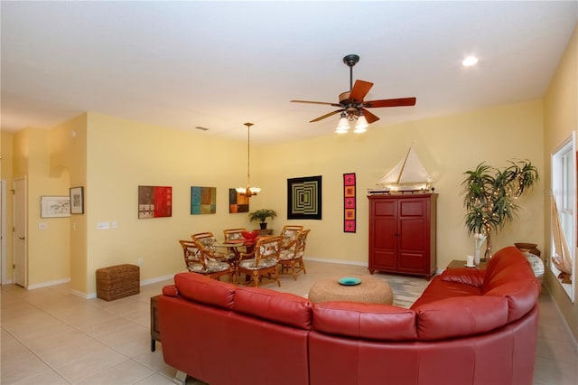 living room featuring light tile patterned floors and ceiling fan with notable chandelier